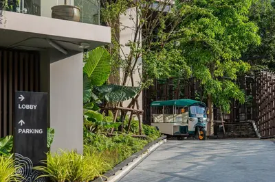 a small vehicle parked next to a building at Gardina Asoke Hotel & Residence in Bangkok