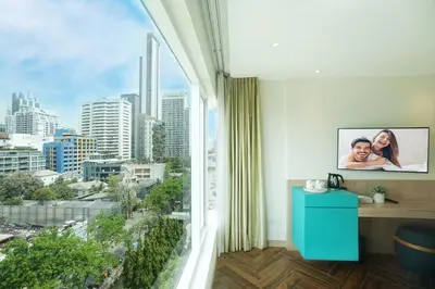 a room with a window with a view of a city at SQ Boutique Hotel in Bangkok