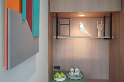 a kitchen with a shelf with a bowl of fruit at SQ Boutique Hotel in Bangkok