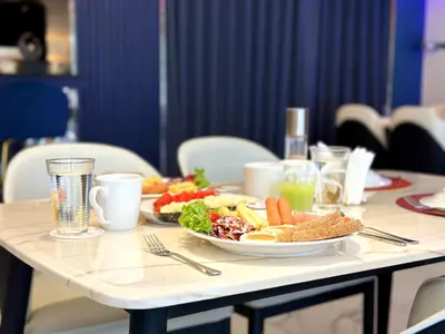 a table with two plates of food on it at SQ Boutique Hotel in Bangkok