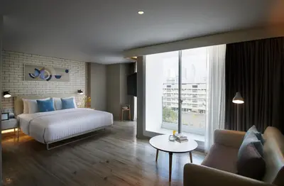 a hotel room with a bed and a couch at Shama Yen-Akat Bangkok in Bangkok