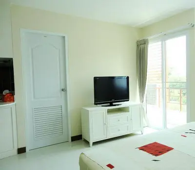 a bedroom with a television on a white cabinet at Charming Resident near BTS Ekkamai Station in Bangkok