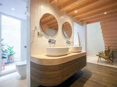 a bathroom with two sinks and two mirrors at Bonsai Hotel Bangkok in Bangkok