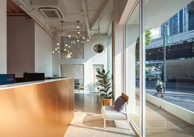 an office with a reception desk and a chair at Bonsai Hotel Bangkok in Bangkok