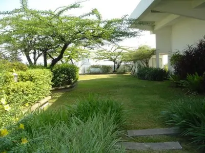 a yard with plants and trees and a house at Stunning 24th Fl Terrace Penthouse! in Bangkok