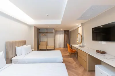 a hotel room with two beds and a television at Away Bangkok Riverside Kene in Bangkok