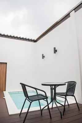 a table and two chairs on a balcony at VEVILLA in Bangkok