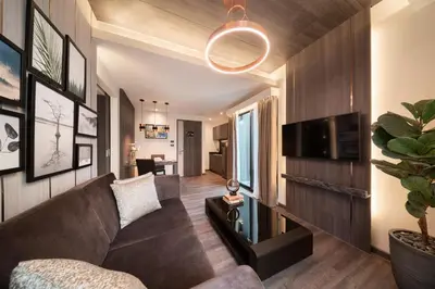 a living room with a couch and a tv at Aspira Parc Sukhumvit 22 in Bangkok