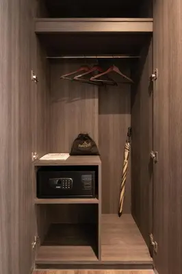 a closet with a microwave and a baseball bat at Aspira Parc Sukhumvit 22 in Bangkok