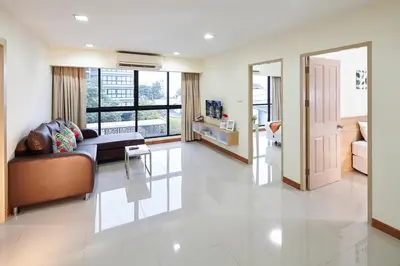 a living room with a couch and a table at The Plimplace Hotel in Bang Su
