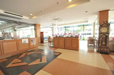 a lobby with a clock in the middle of a building at Bangkok City Suite in Bangkok