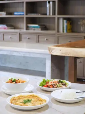 a table with four plates of food on it at Watana Hotel in Bangkok