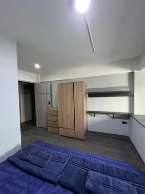 a bedroom with a bed and a wooden cabinet at W71 in Bangkok