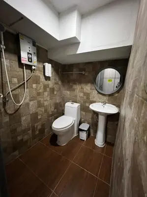a bathroom with a toilet and a sink at W71 in Bangkok