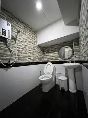 a bathroom with a shower and a toilet and a sink at W71 in Bangkok