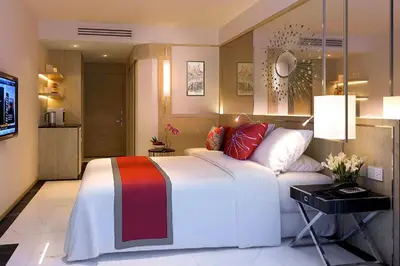 a bedroom with a large bed and a television at FX HOTEL NANA in Bangkok