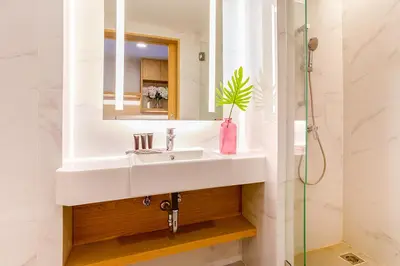 a bathroom with a sink and a mirror at FX HOTEL NANA in Bangkok