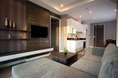 a living room with a couch and a flat screen tv at J Residence Thonglor 8 in Bangkok