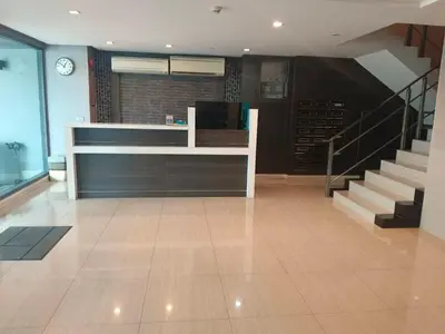 a lobby with a staircase and a reception desk at J Residence Thonglor 8 in Bangkok