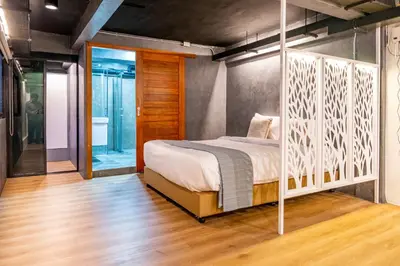a bedroom with a bed with a white bed frame at Usman Halal Home in Bangkok