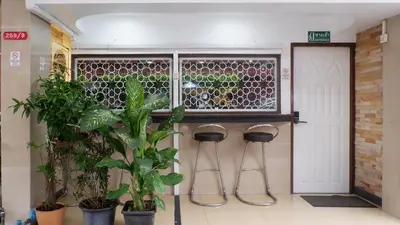 a room with three stools and a window with plants at Usman Halal Home in Bangkok