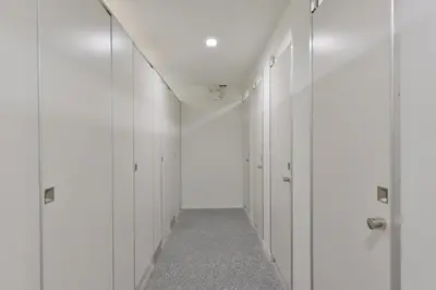 an empty hallway with white walls and a long corridor at Tiang Capsule in Bangkok