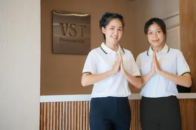 two girls are doing a gesture in a room at VST Punnawithi in Bangkok