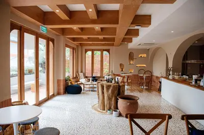 a large room with tables and chairs and windows at VST Punnawithi in Bangkok