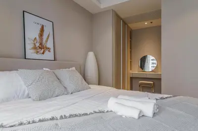 a bedroom with a white bed with white pillows at Sukhumvit 11#Luxury#Pool#Gym#BTS Nana&MRT Sukhumvit#1BR#Max2ppl in Bangkok