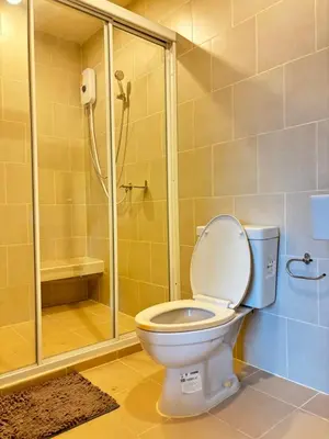 a bathroom with a toilet and a shower at Entire apartment near train station with pool & views in Ban Song Hong