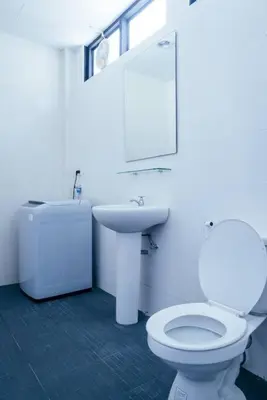 a white bathroom with a toilet and a sink at T4 Two Bedrooms Full kitchen/1 min to BTS in Bangkok