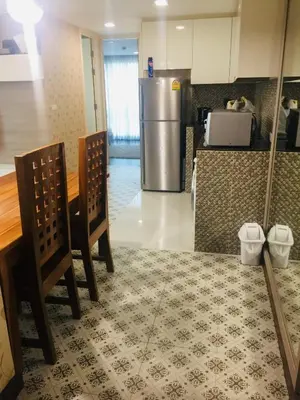 a kitchen with two chairs and a refrigerator at Liv at 5 room41 in Bangkok