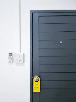 a blue door with a yellow sign next to it at The zai Apartment in Ban Krathum Lom