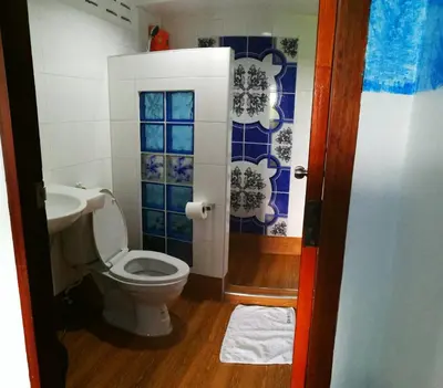 a bathroom with a toilet and a sink at Room For You in Bangkok