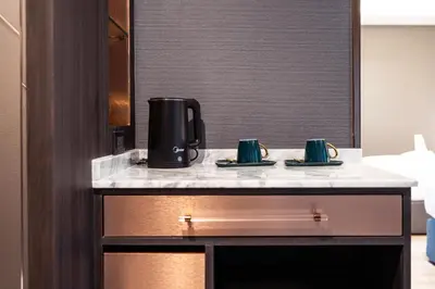 a coffee maker on a counter in a hotel room at The One Smart Living in Bangkok
