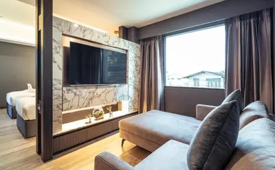 a hotel room with a large window and a tv at The One Smart Living in Bangkok