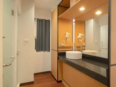 a bathroom with a sink and a mirror at Watergate City in Bangkok