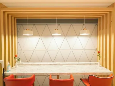 a dining room with orange chairs and a table at Watergate City in Bangkok