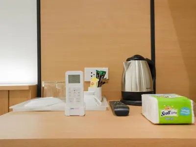a kitchen counter with a phone and a coffee maker at Watergate City in Bangkok
