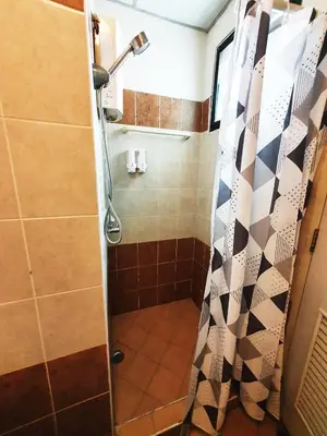 a bathroom with a shower with a shower curtain at 552 Residence in Bangkok
