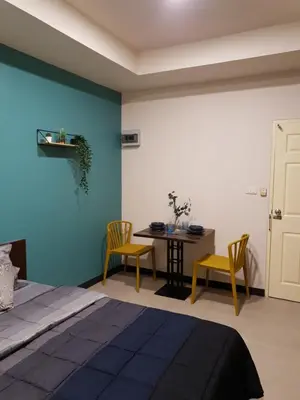 a bedroom with a bed and a table and chairs at 552 Residence in Bangkok