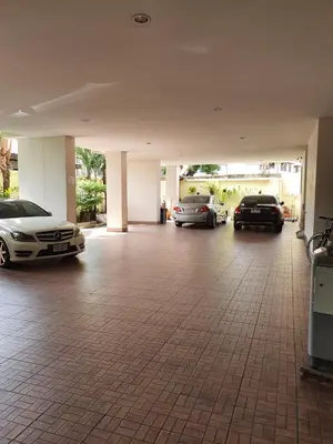 a garage with three cars parked in it at 552 Residence in Bangkok