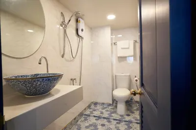 a bathroom with a bowl sink and a toilet at Sweet's Escape in Bangkok