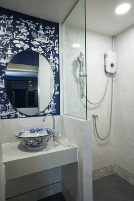 a bathroom with a sink and a mirror at Sweet's Escape in Bangkok