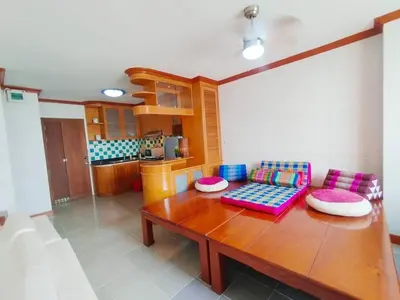 a living room with a wooden table and chairs at The Park Land Bangna by Nudda in Bangkok