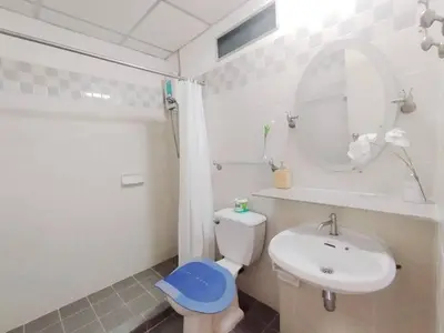 a bathroom with a toilet and a sink and a mirror at The Park Land Bangna by Nudda in Bangkok
