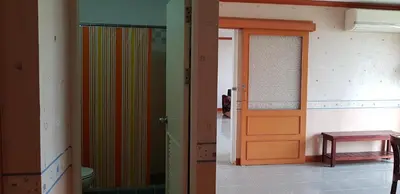 a hallway with an orange door and a room at The Park Land Bangna by Nudda in Bangkok