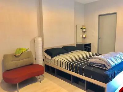 a bedroom with a bed and a chair at New condominium on Sukhumvit Road 