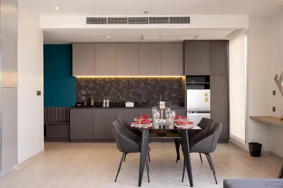 a kitchen and dining room with a table and chairs at Thaya Hotel Bangkok in Bangkok