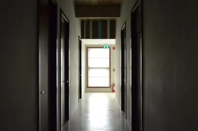 an empty hallway with a door leading to a window at Villa Bangkok in Bangkok